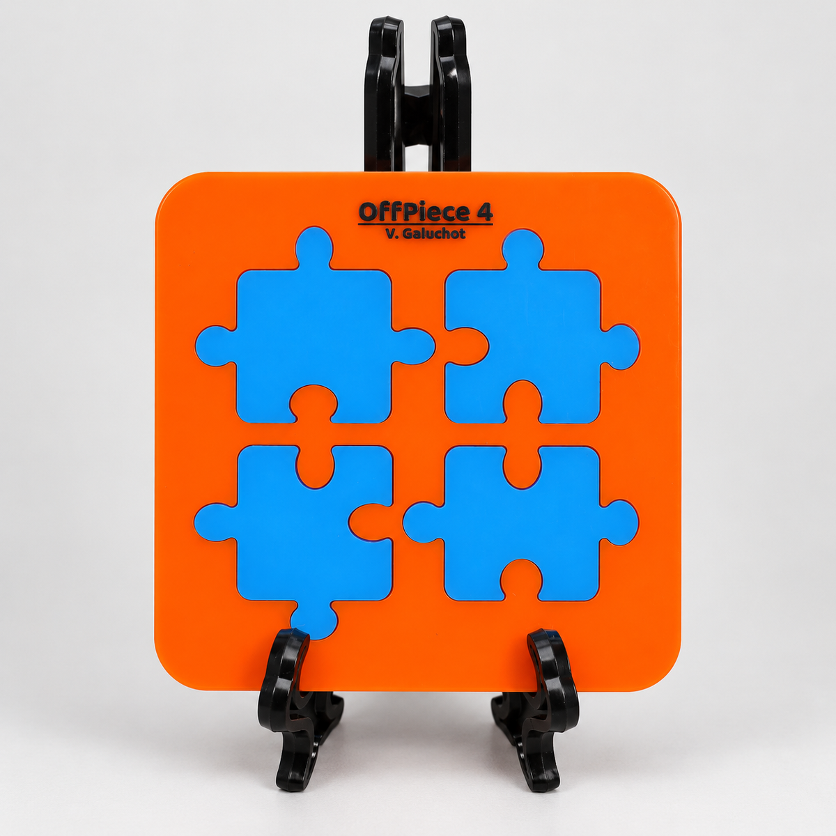 OffPiece 4 four blue jigsaw pieces in orange acrylic display frame with original stand