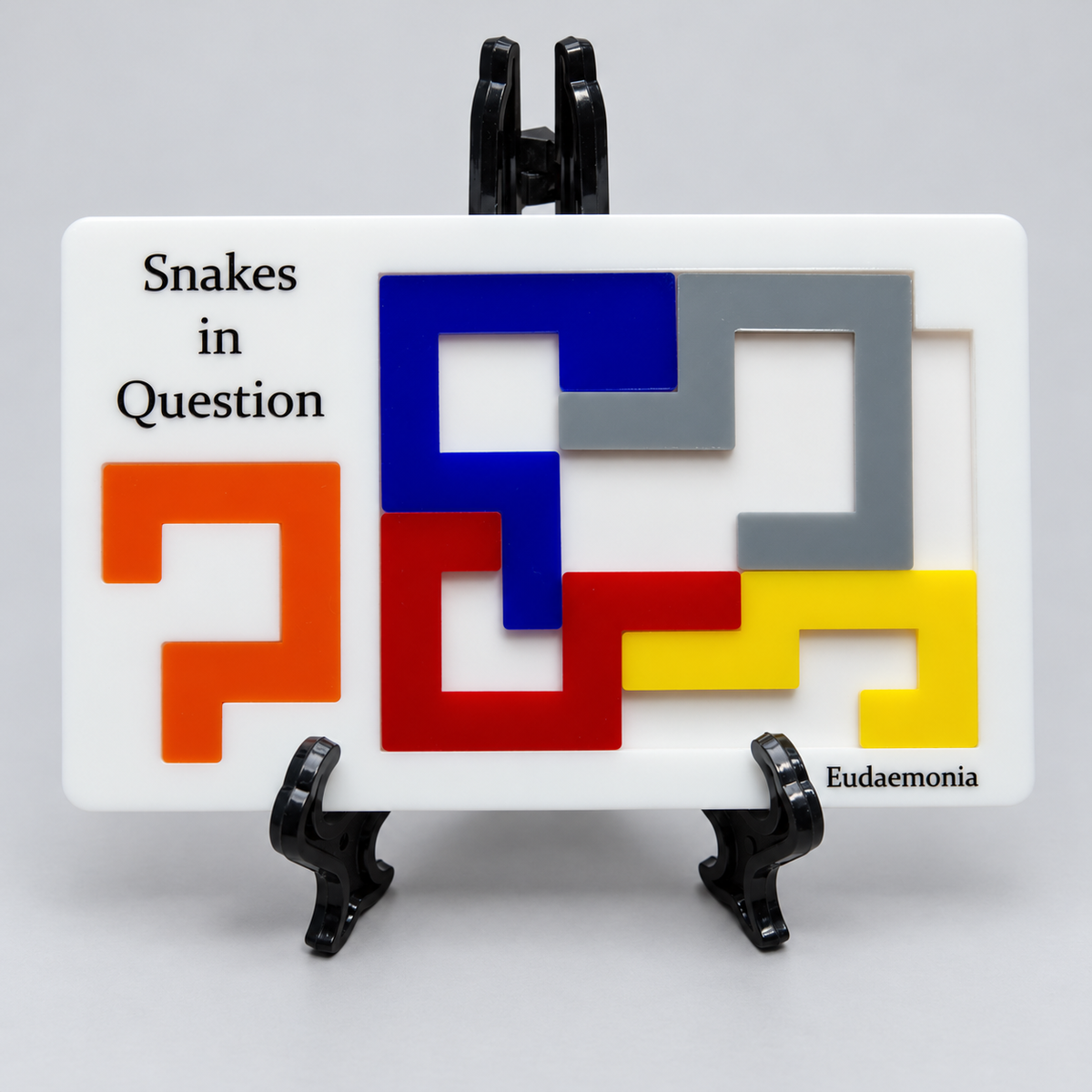 Snakes in Question five colored acrylic pieces, white tray and original stand